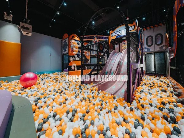 Space-efficient design combining multiple play zones in a commercial indoor playground.