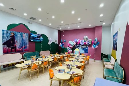 A vibrant and decorated party room in an indoor playground, ready for a celebration.