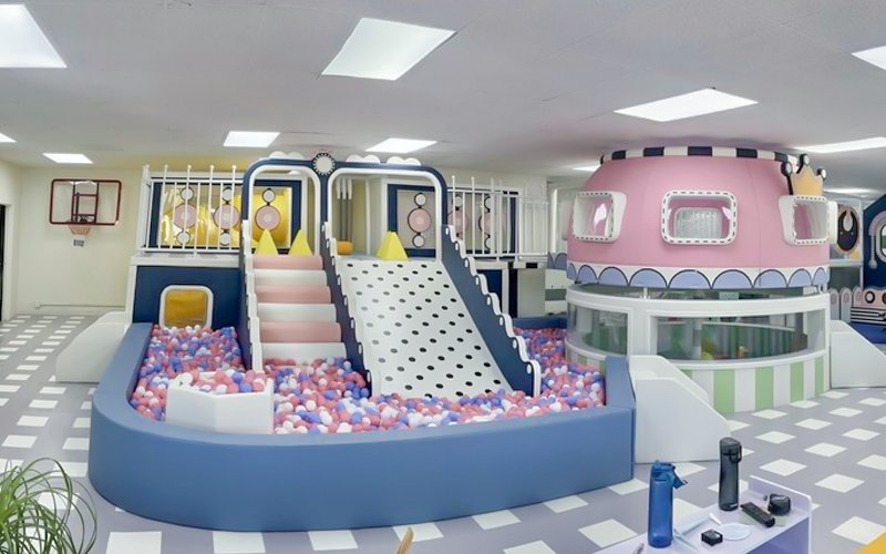 Children enjoying a paid play session inside a modern indoor play center