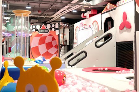 Large trumpet slide in indoor playground equipment for home commercial spaces.